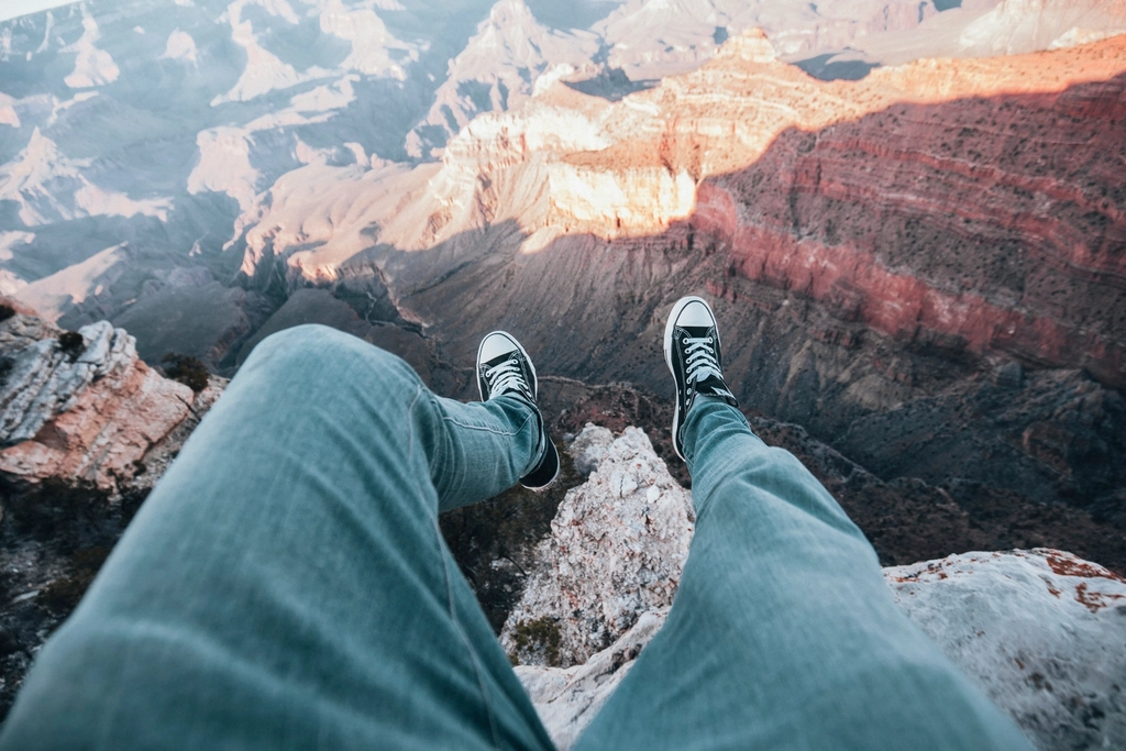 Person sitting cliff, Grand Canyon