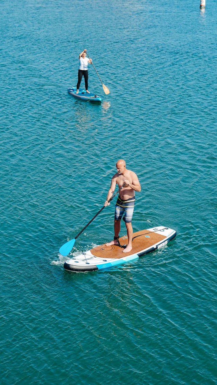a man and a woman on paddleboards