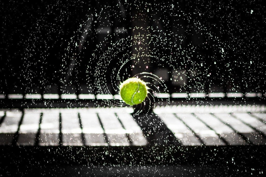 Wet tennis ball spinning water