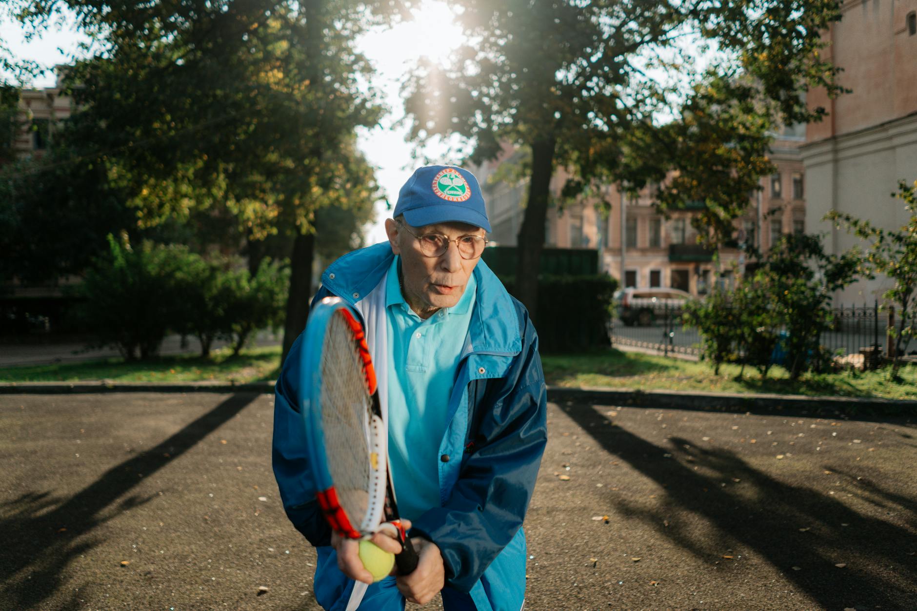 elderly man playing tennis