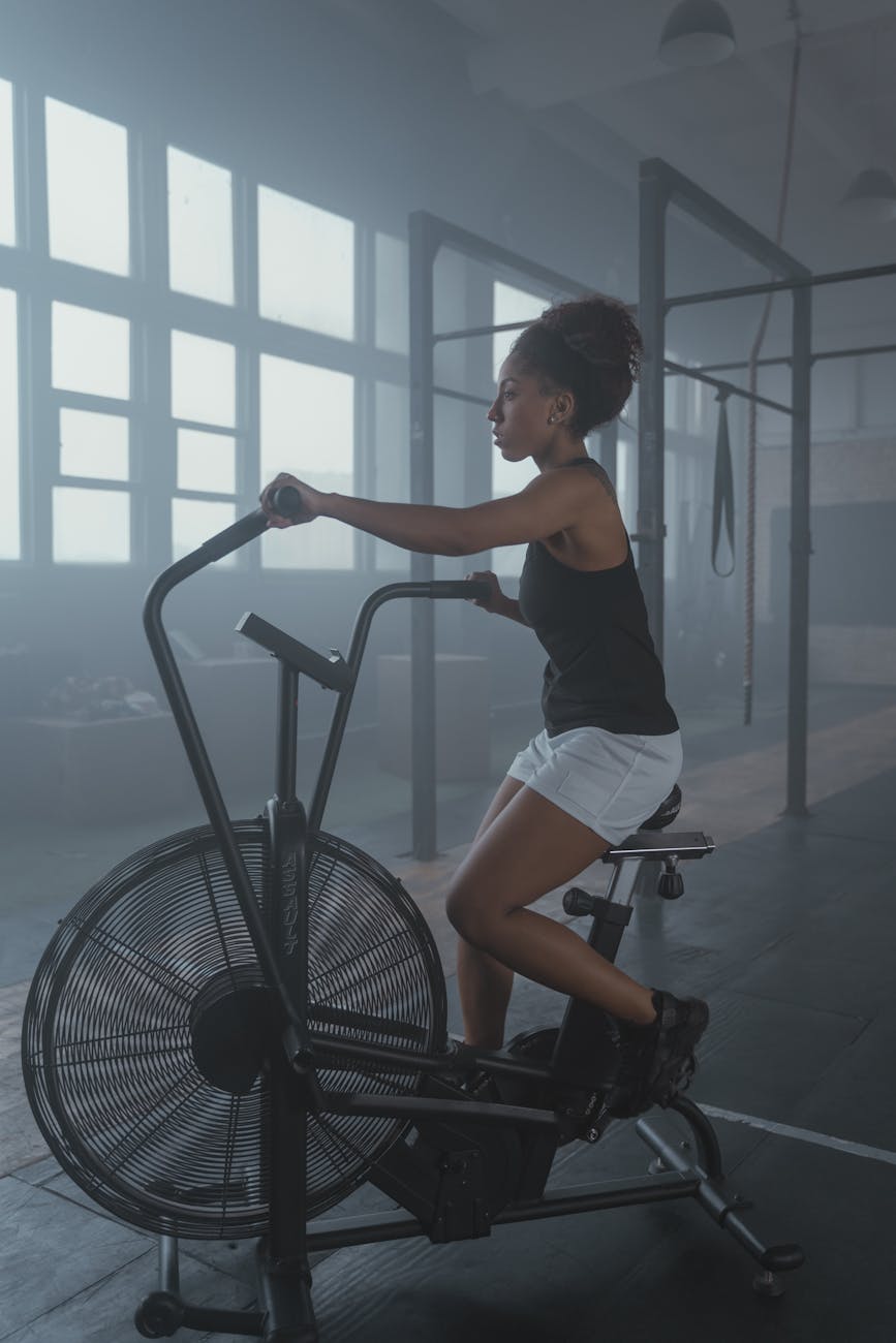 a woman exercising on an air bike