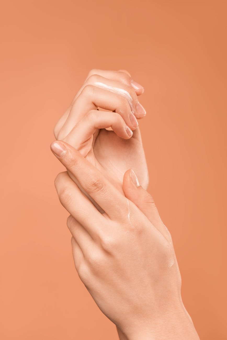 persons hand on orange background