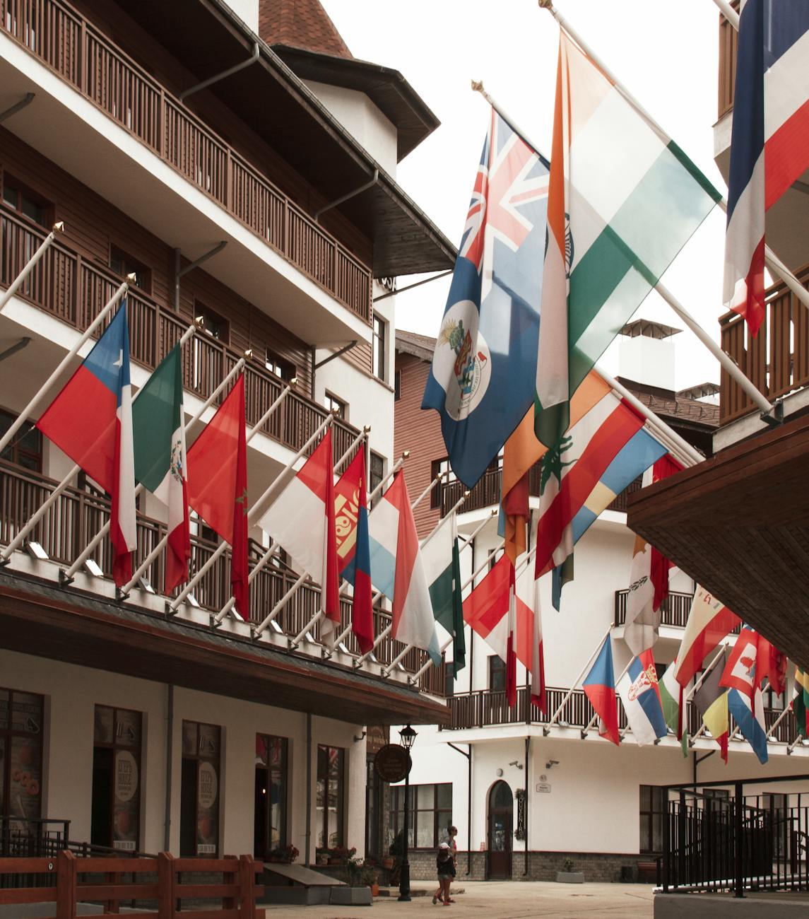 olympic village with collection of national flags on building walls